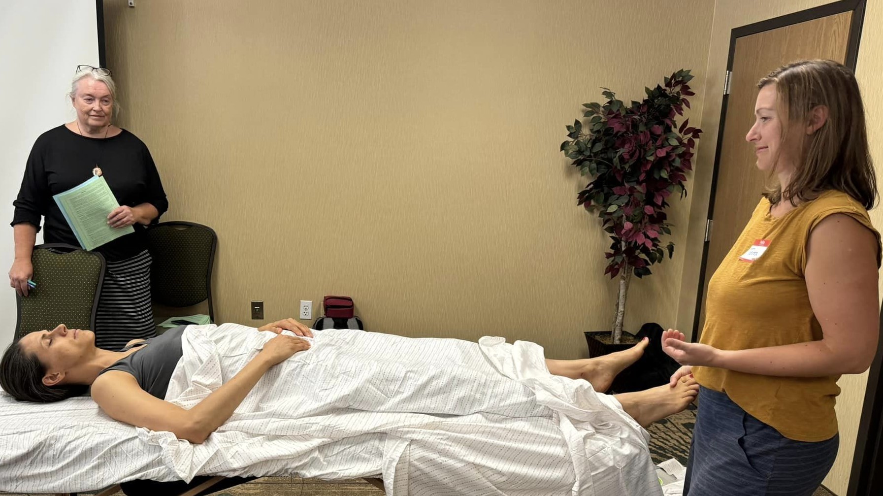 Relationship and Connection 7 Terra McAuliffe, CI demonstrating Vitaflex on the spinal points of the feet