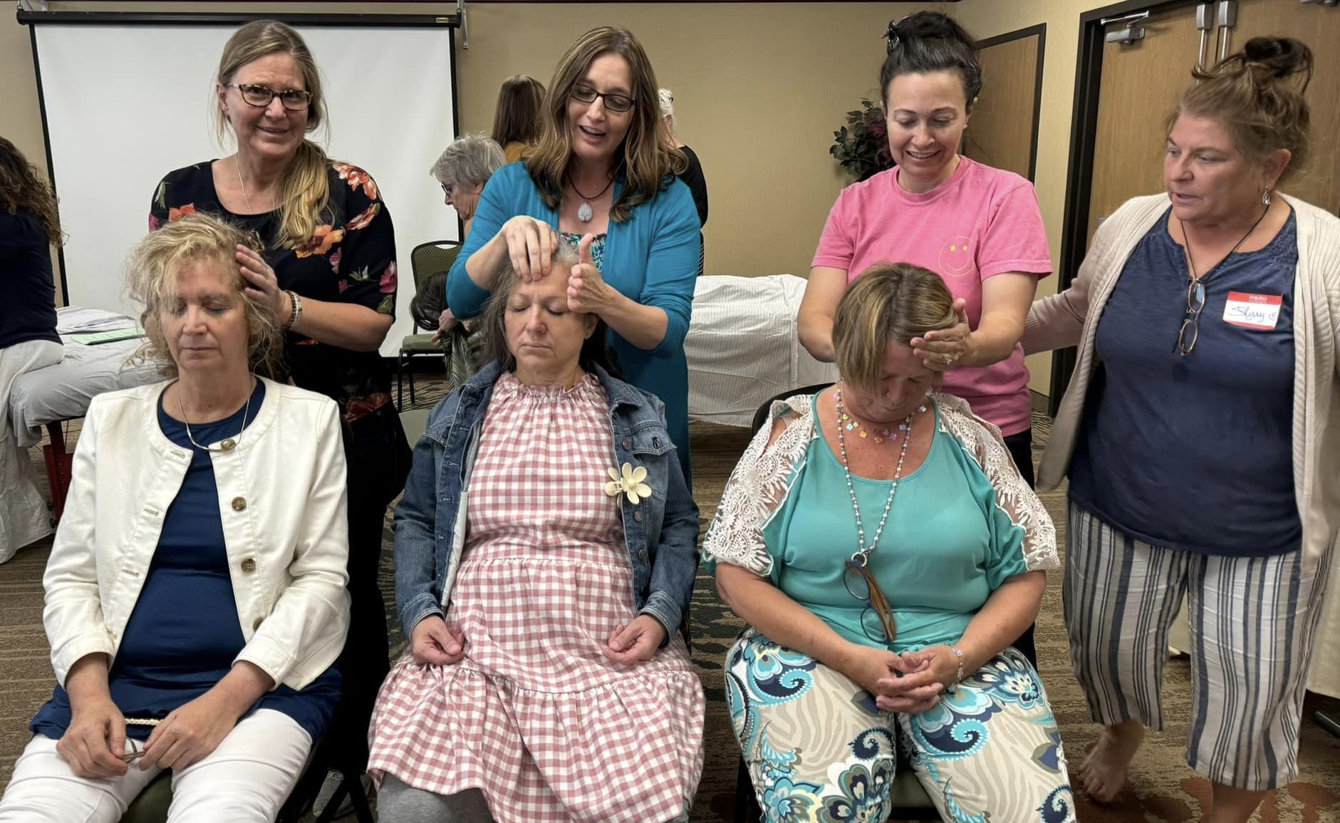 Relationship and Connection 12 CARE Instructors demonstrating Vitaflex on the head